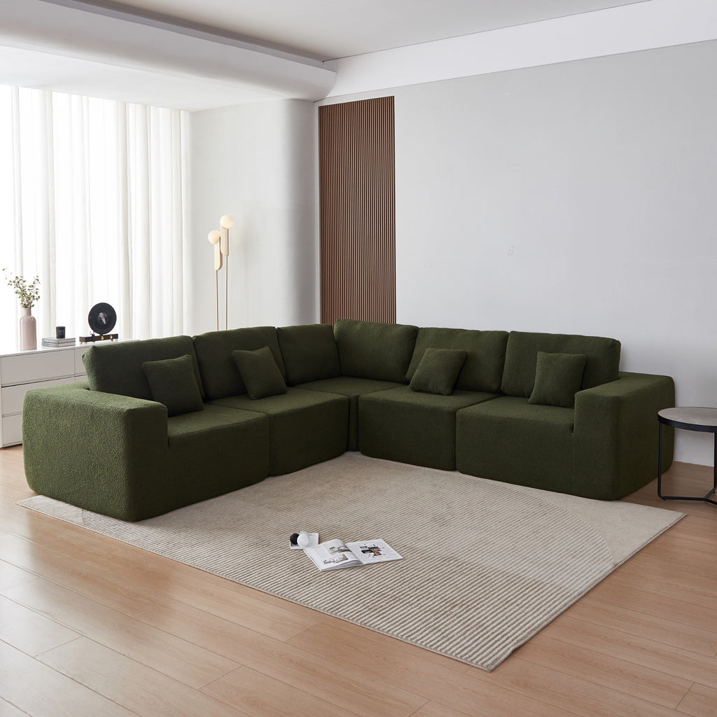 A forest green 5-seater modular sofa with a corner unit and two armrest ends, made with a low-profile and minimalistic design in a room with a carpet.