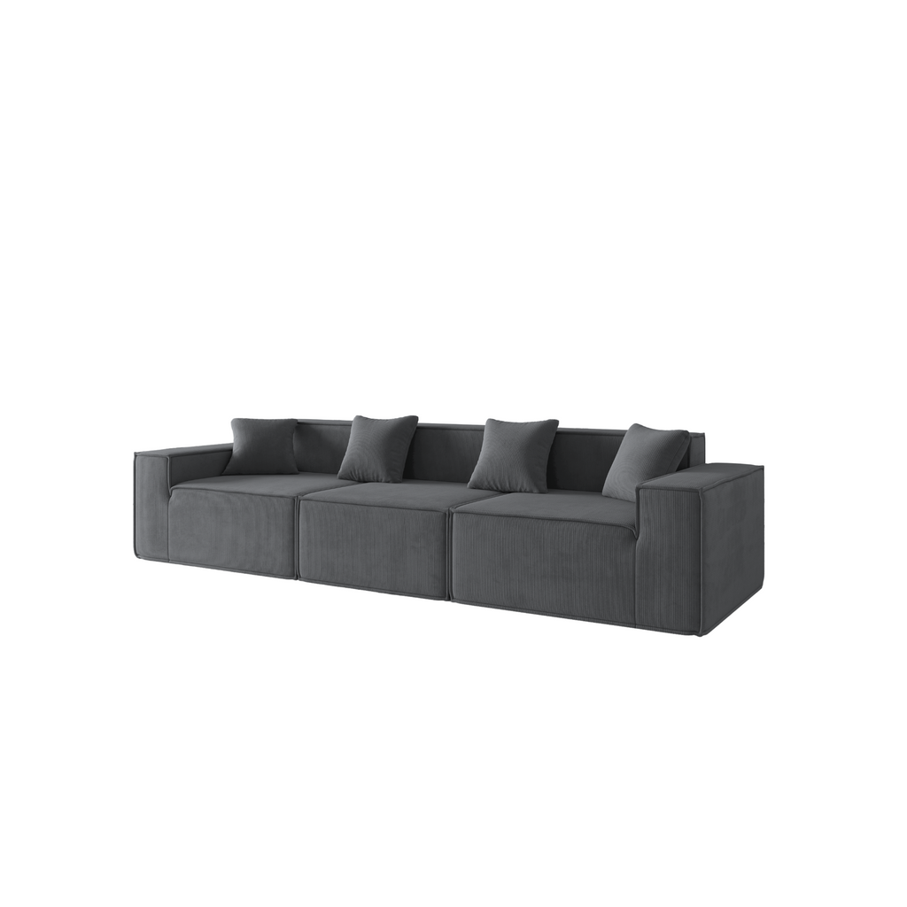 A slate grey three-seater corduroy sofa with an ottoman, featuring a modern, low-profile design with plush cushions