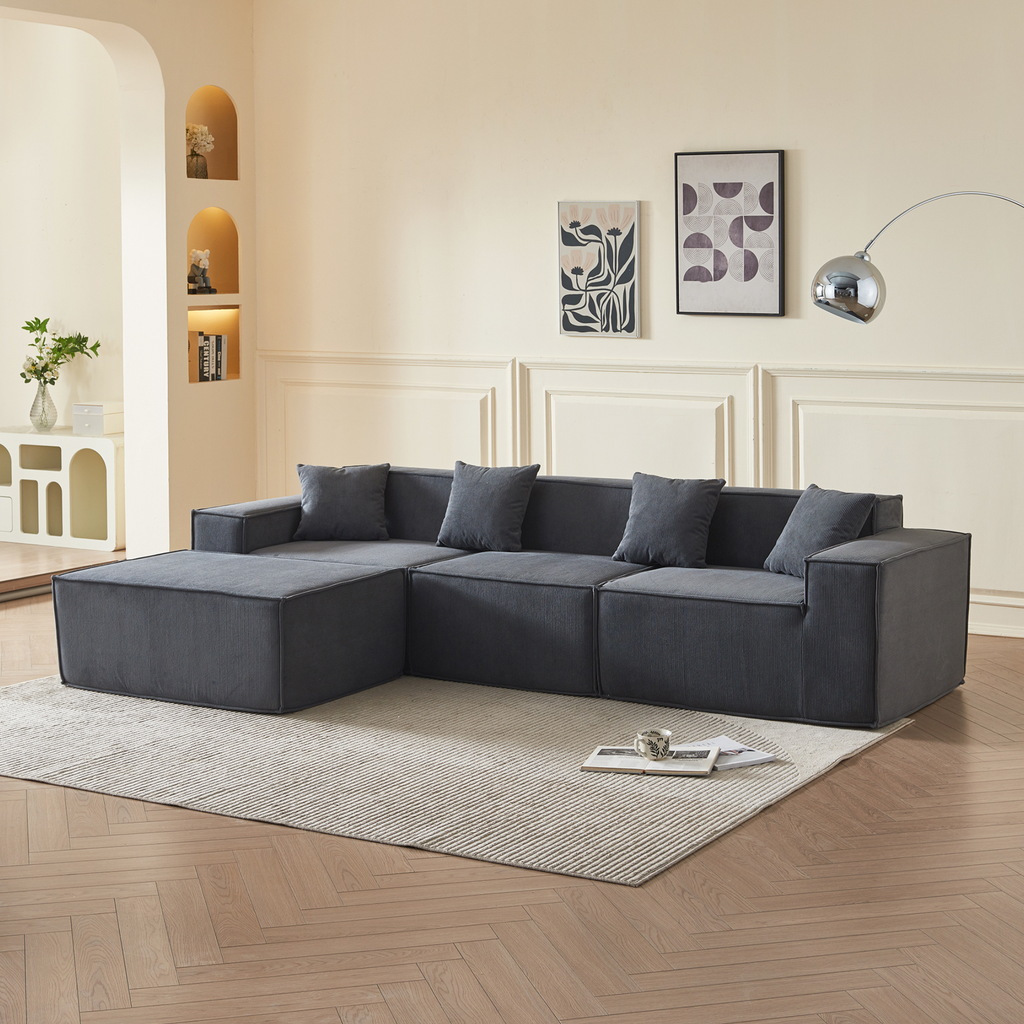A slate grey three-seater corduroy sofa 