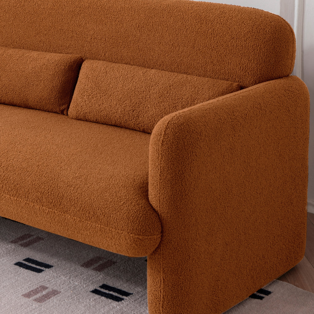 An amber two-seater sofa with a minimalist design, featuring a low profile and smooth lines