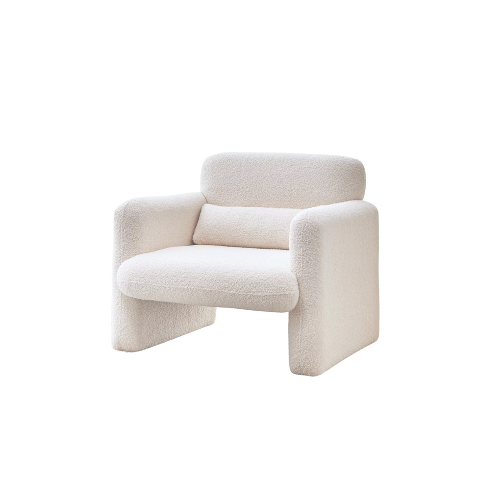 A cream-coloured Astrid Armchair with a minimalist design, featuring a luxurious feel and constructed from interlocking panels.