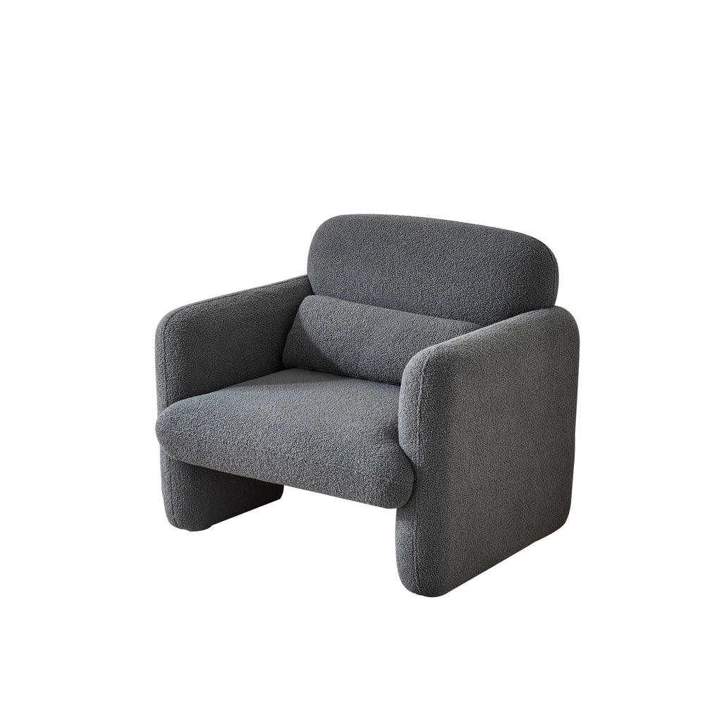 A grey upholstered Astrid Armchair with a minimalist design, consisting of four interlocking panels for the seat, back, and sides.