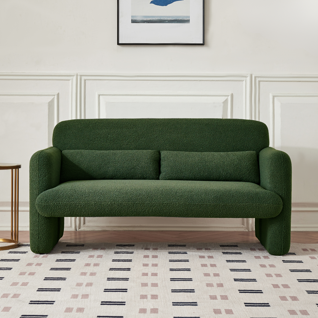 A forest green two-seater sofa with a minimalist design, featuring a low profile and sleek silhouette, made with synthetic lambswool upholstery on a carpet.