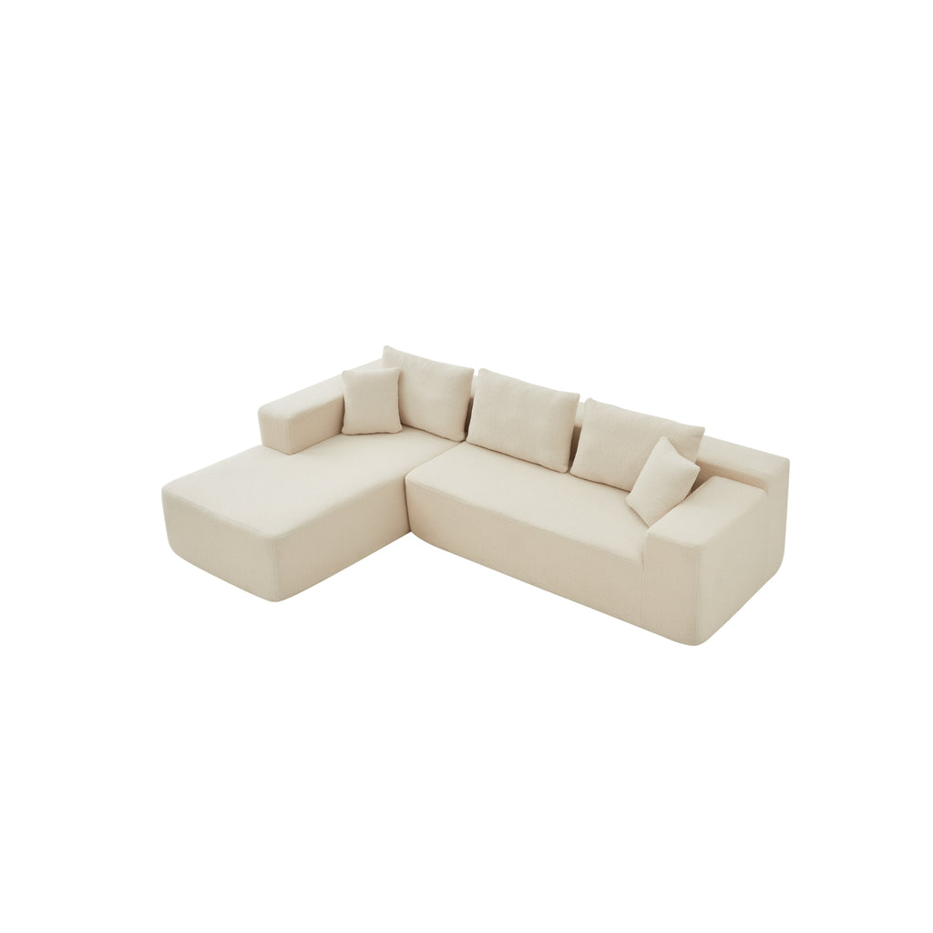 A top view cream modular sofa with a left-arm chaise and right-arm seat, upholstered in synthetic lambswool, with a low-profile design.