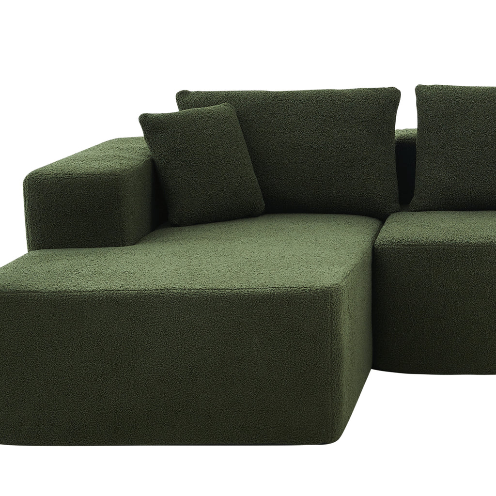 A forest green modular sofa with a left-arm chaise and right-arm seat, upholstered.