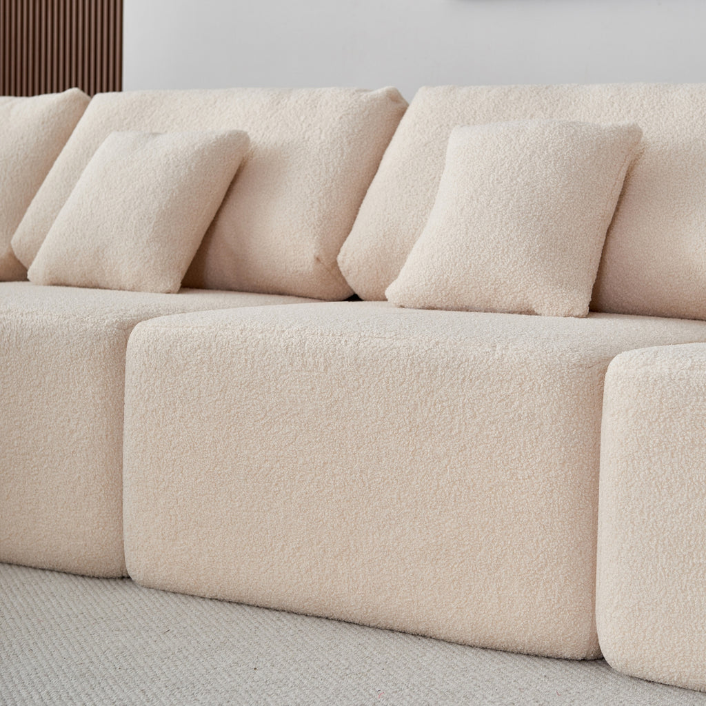 A close-up cream 5-seater modular sofa with a minimalistic design