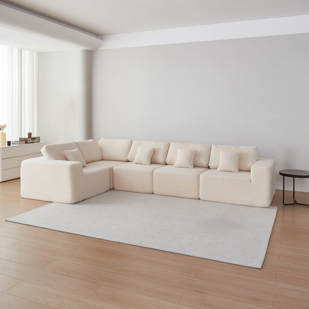 A cream 5-seater modular sofa with a minimalistic design in a modern room
