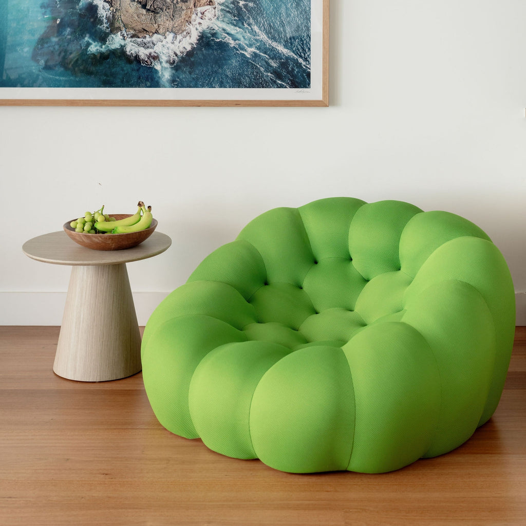 Cosmo Sofa photos green in a room with a neutral wall and abstract art.