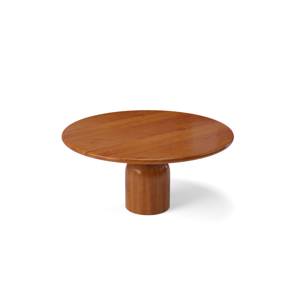 Round cherry wood dining table with a central pedestal base.