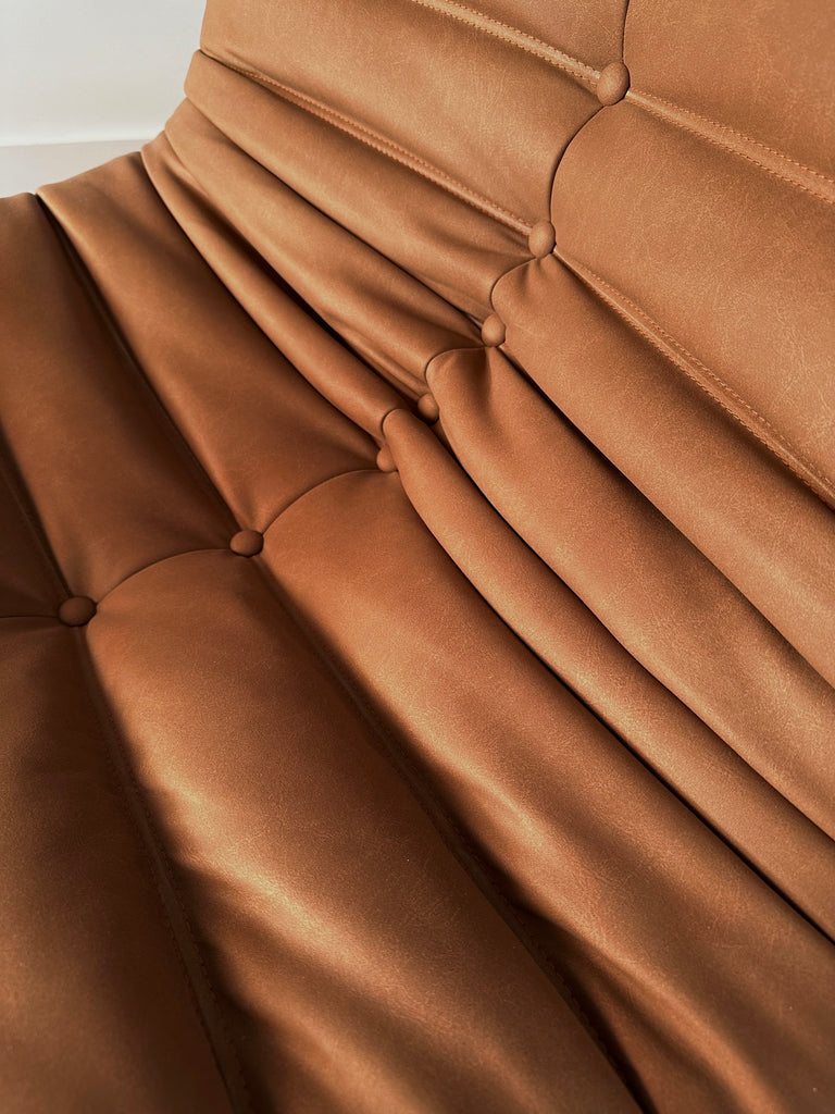 A close-up view of the Junii Fireside sofa with mid-century modern charm.  