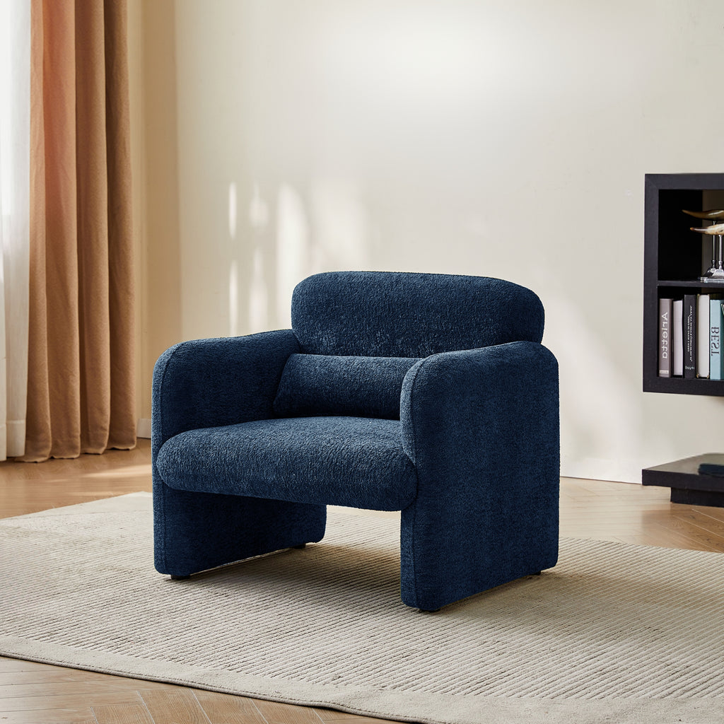 Blue armchair in a living room setting with a neutral colour palette