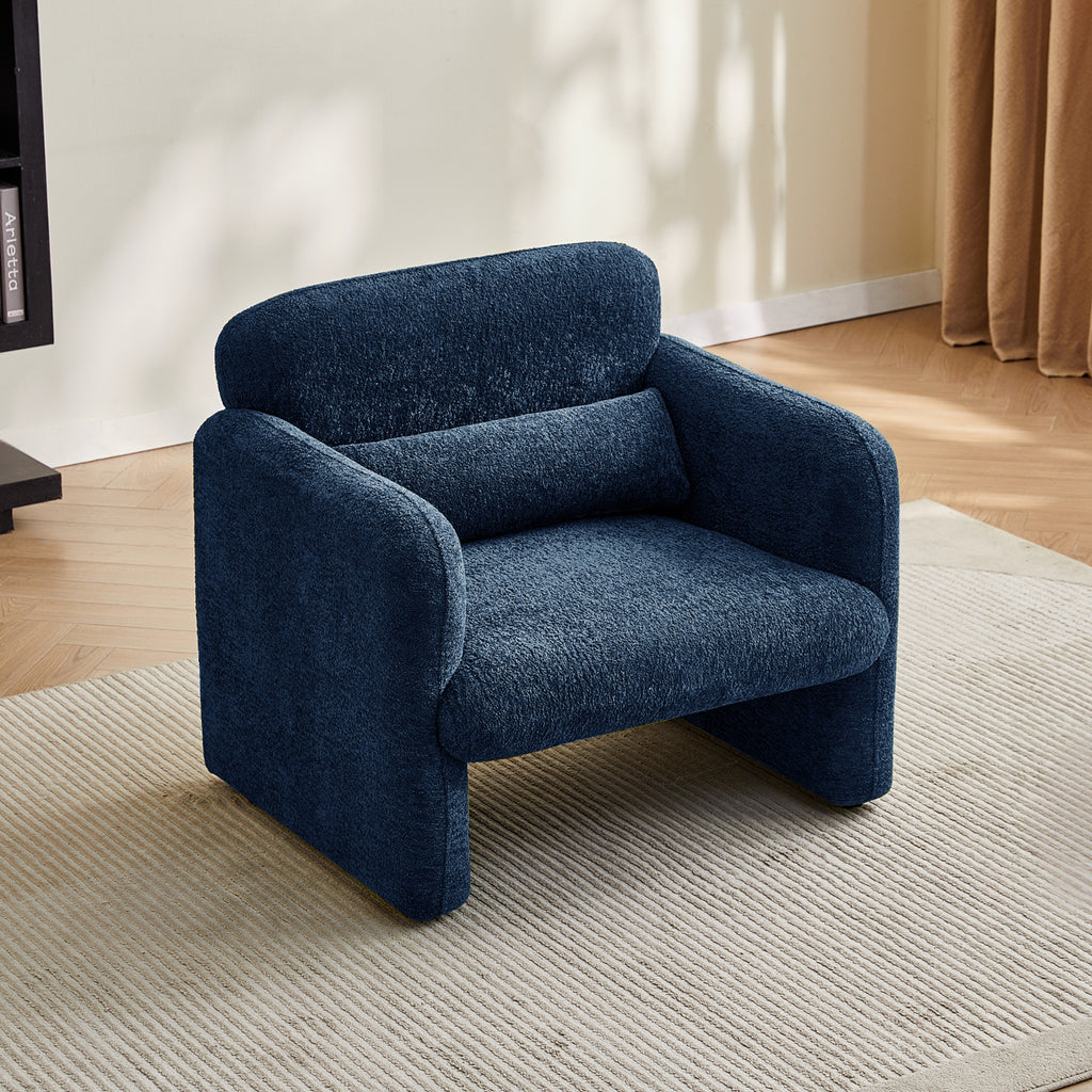 Navy blue armchair in a room with a neutral colour scheme