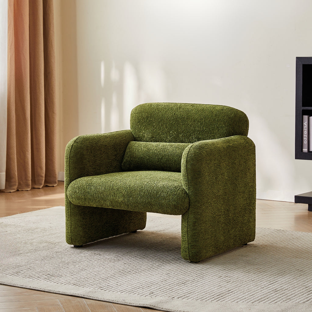 Green armchair in a room with a beige curtain and wooden floor.