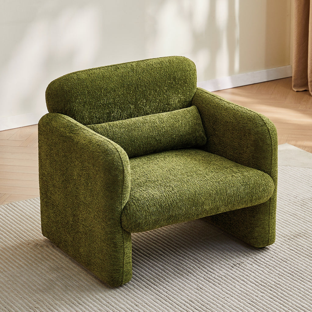 Olive green armchair in a room with light-colored walls and a wooden floor