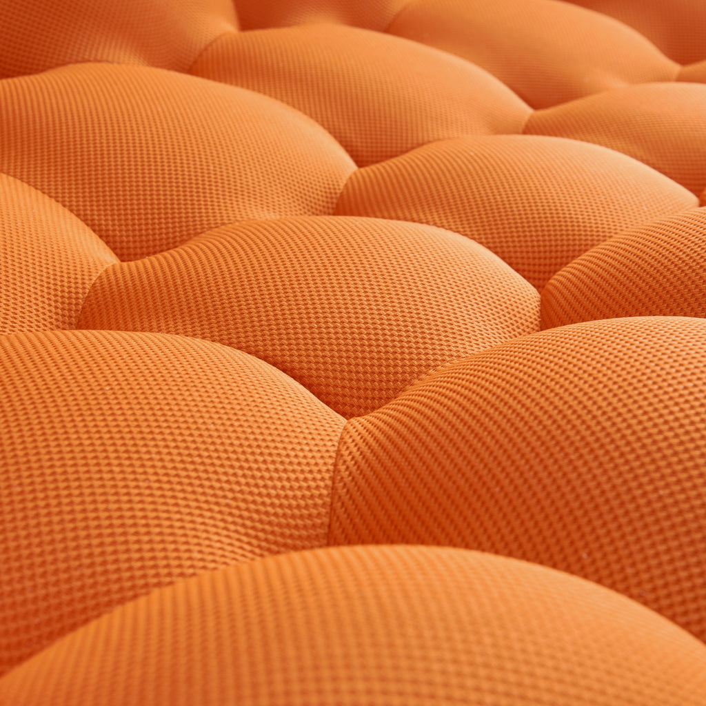 Close-up of a tangerine orange textured cushion