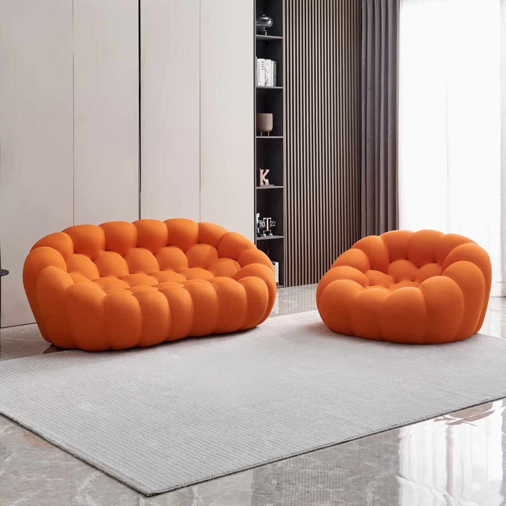 Two tangerine orange bubble chairs in a modern living room setting.