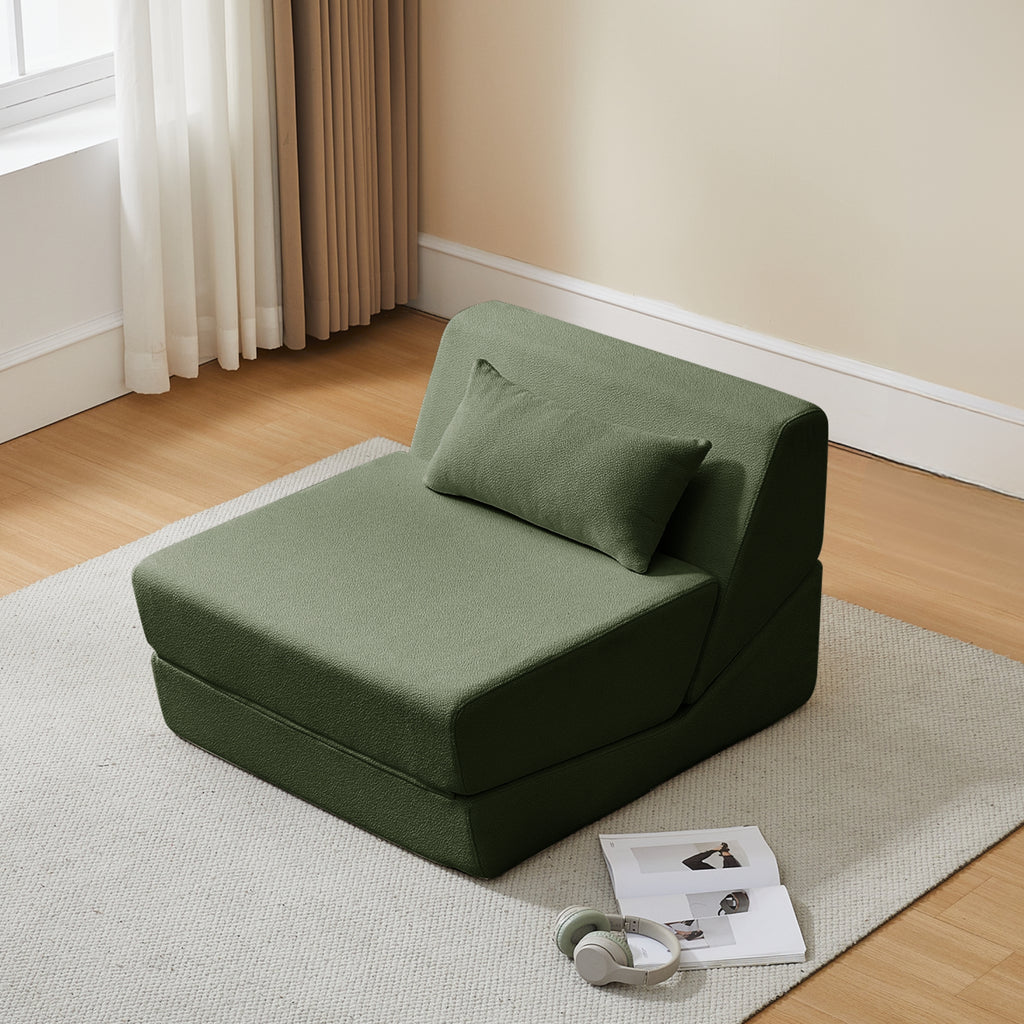 Turtle green cushioned chair on a rug in a room with curtains and a window.