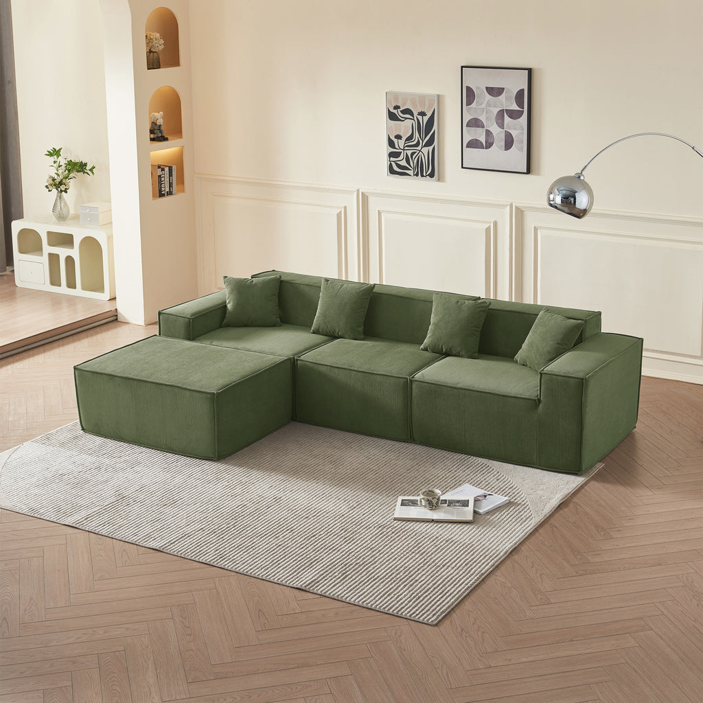 Olive sectional sofa in a living room with a wooden floor and decorative elements.