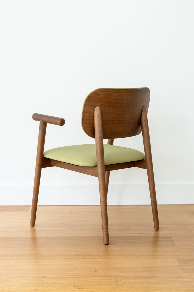 A back view of Kyoto Dining Chair with a green cushioned seat and backrest