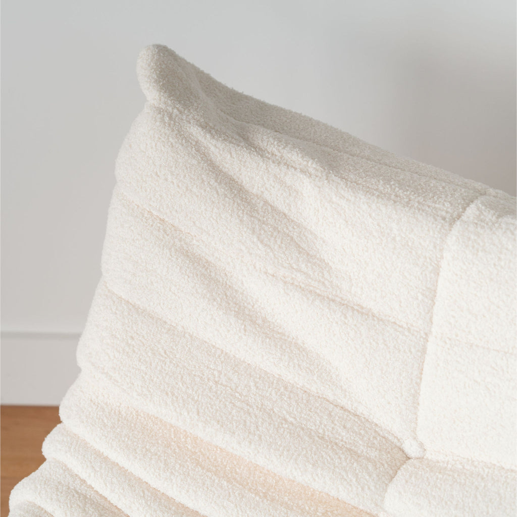 Lola Single Sofa cream-coloured with a pillow on a white background