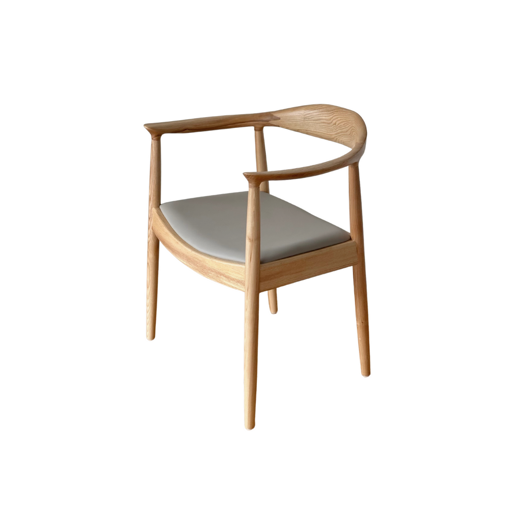 A natural timber dining chair with a pebble grey seat cushion, with a full backrest and armrests.